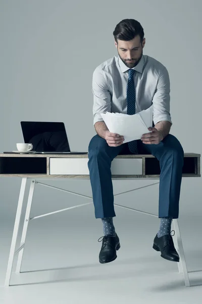 Businessman sitting on table — Stock Photo