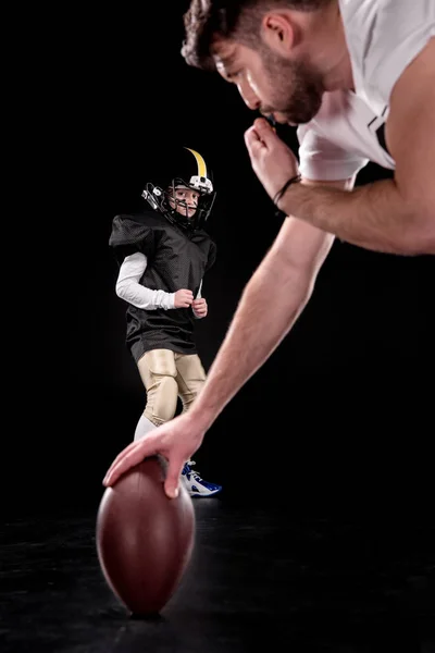 Boy playing football with trainer — Stock Photo