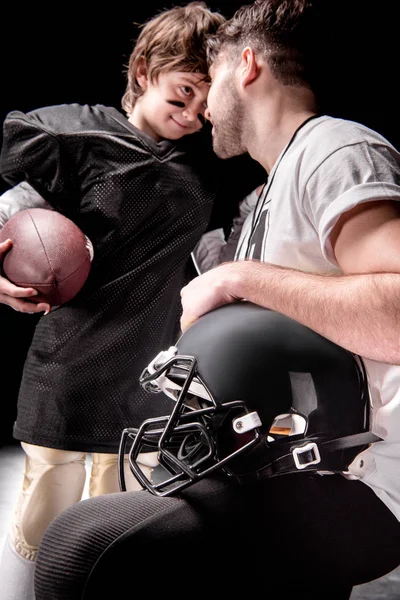 Boy playing football with trainer — Stock Photo