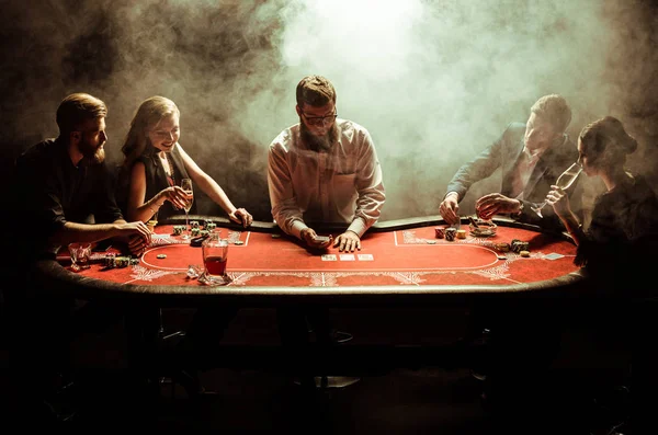 Young people playing poker — Stock Photo