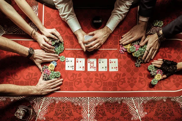 Young people playing poker — Stock Photo