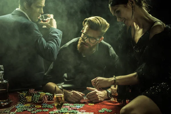 Young people playing poker — Stock Photo