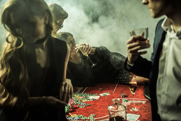 Young people playing poker — Stock Photo