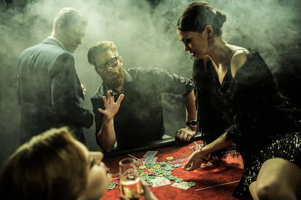 Young people playing poker — Stock Photo