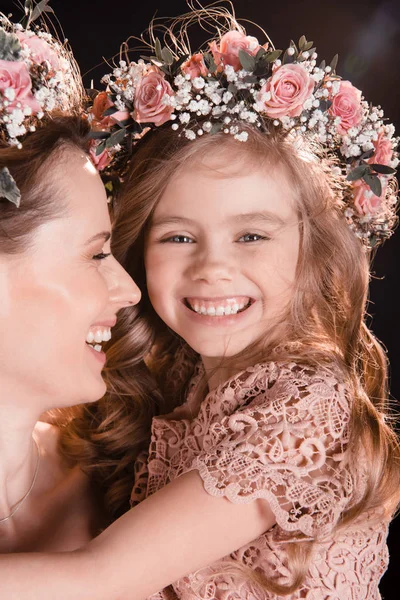Mother and daughter in wreaths — Stock Photo