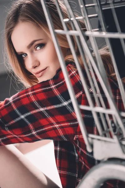 Young woman with shopping cart — Stock Photo