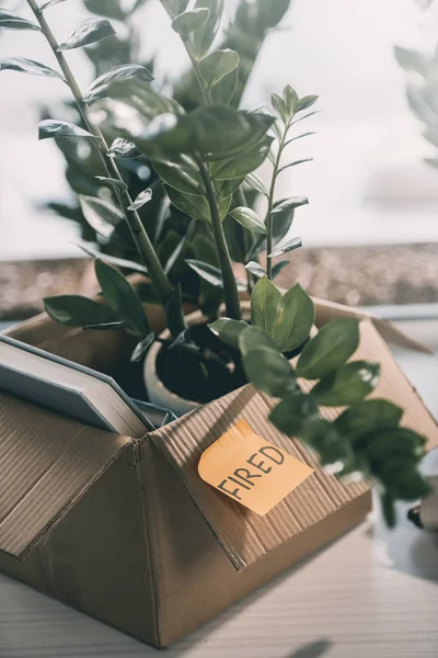 Box and note with word fired — Stock Photo