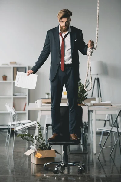 Businessman trying to hang himself — Stock Photo