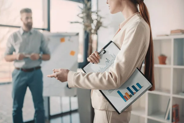 Young businesswoman with clipboard — Stock Photo