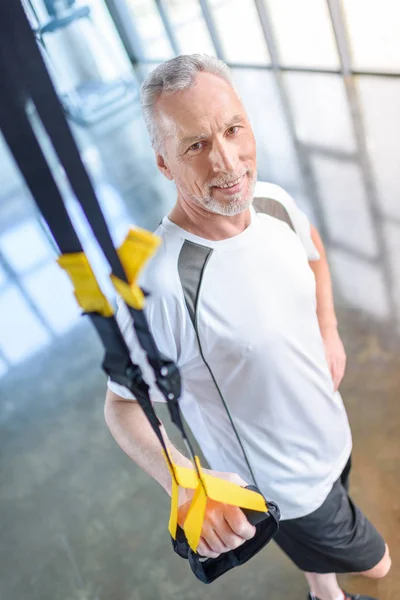Sportsman training with resistance band — Stock Photo