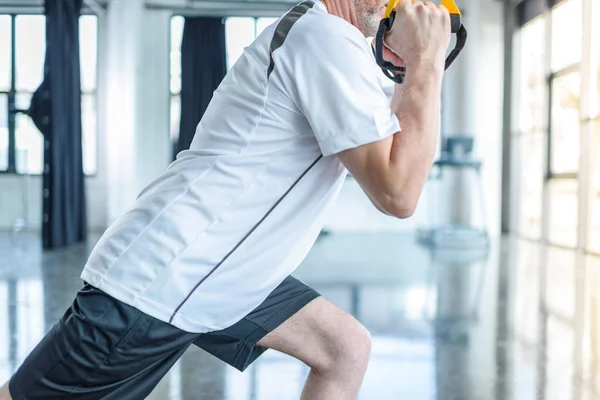 Sportsman training with resistance band — Stock Photo