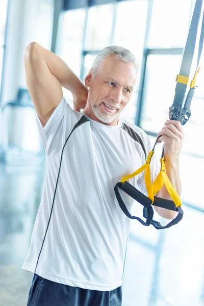 Sportsman training with resistance band — Stock Photo
