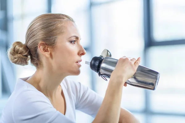 Sportswoman drinking water — Stock Photo