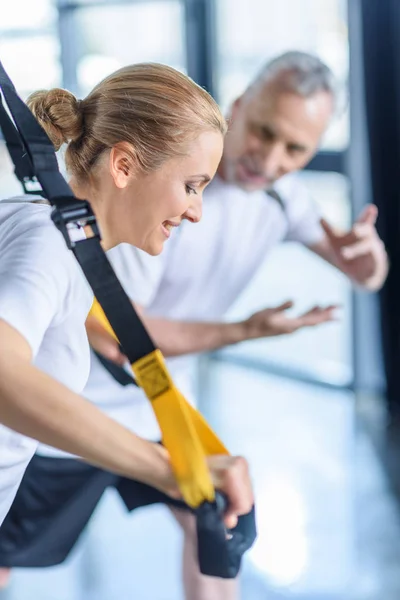 Sportswoman training with resistance band — Stock Photo