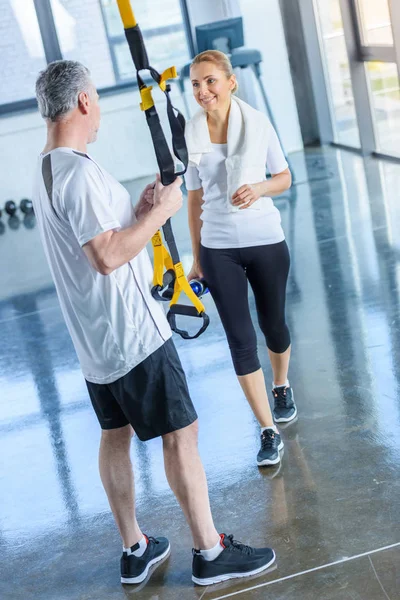 Sportswoman and sportsman with resistance band — Stock Photo
