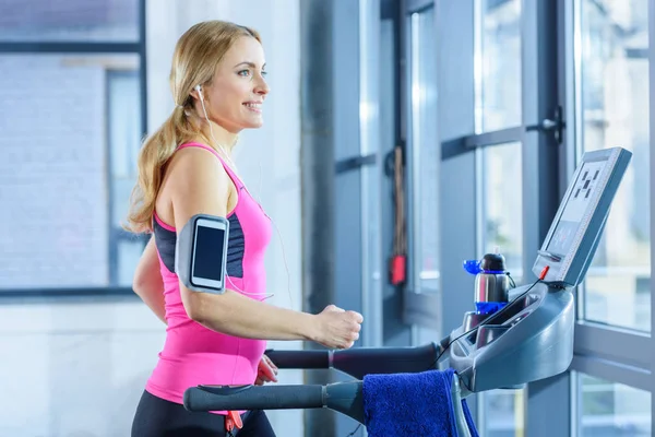 Sporty woman on treadmill — Stock Photo