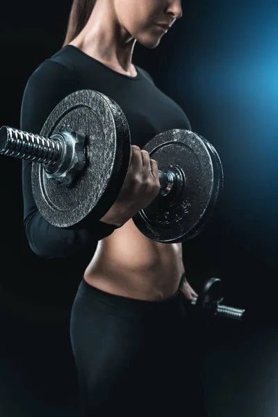 Sportswoman training with dumbbells — Stock Photo