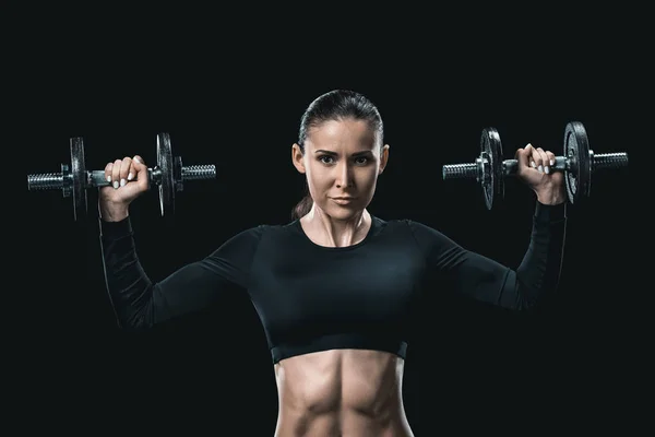 Sportswoman training with dumbbells — Stock Photo