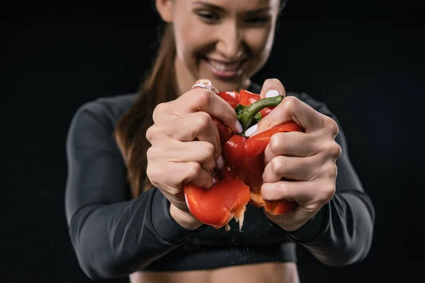 Sportswomen squeezing pepper — Stock Photo