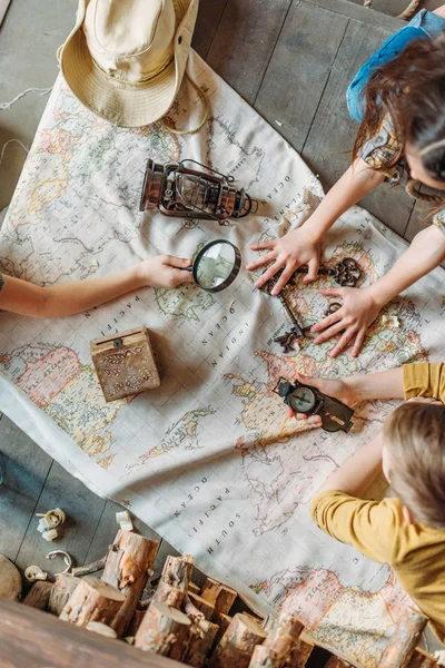 Little travelers with map — Stock Photo