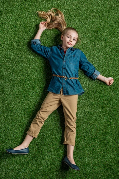 Girl lying on grass — Stock Photo