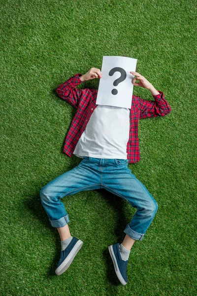 Kid covering face with picture — Stock Photo