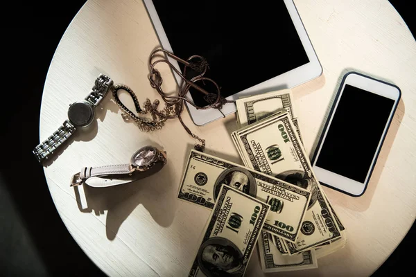 Money and valuables on table — Stock Photo