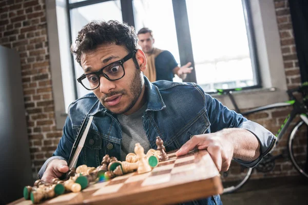 Man holding chess board — Stock Photo