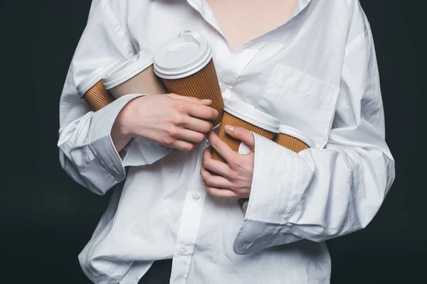 Woman holding pile of disposable coffee cups — Stock Photo