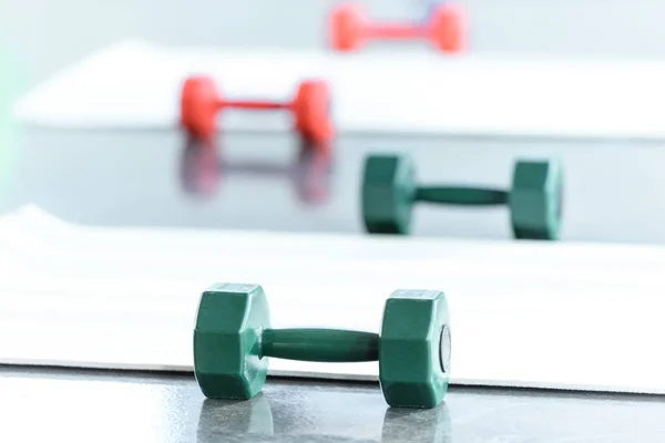 Dumbbells on floor in gum, selective focus — Stock Photo