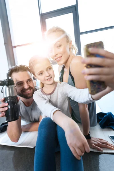 Mädchen macht Selbstporträt mit Eltern im Fitnessstudio — Stockfoto