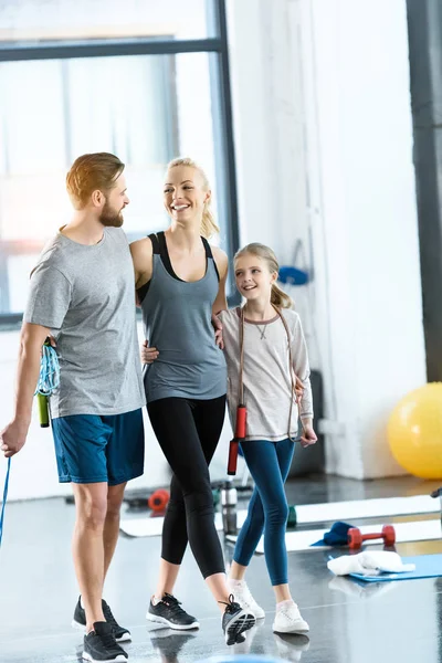Young parents and daughter with skipping ropes at health club — Stock Photo