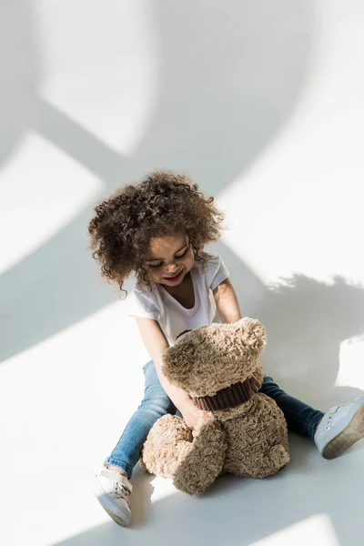 Baby girl with teddy bear — Stock Photo