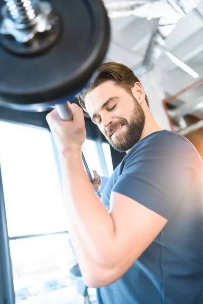 Handsome young guy workout with barbell — Stock Photo