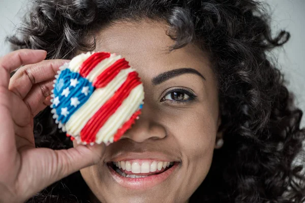 Girl with american flag cupcake — Stock Photo