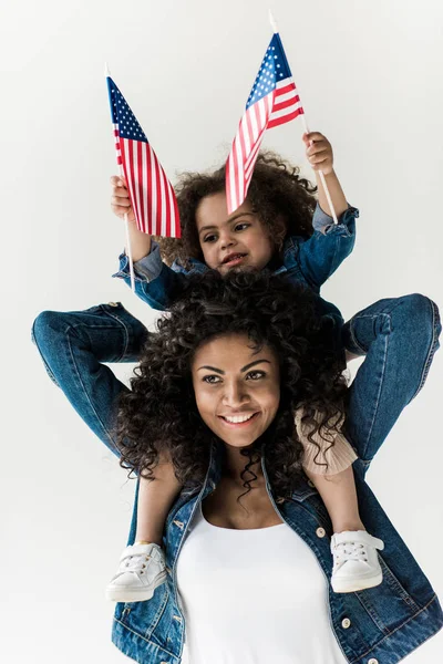 Daughter sitting on shoulders of mother — Stock Photo