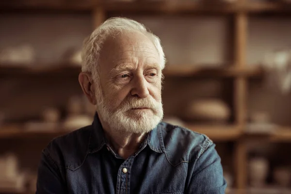 Portrait of senior potter at workshop — Stock Photo