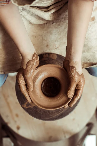 Close up of child hands working on pottery wheel at workshop — Stock Photo