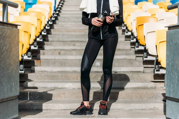 Tired sportswoman on stadium seats — Stock Photo