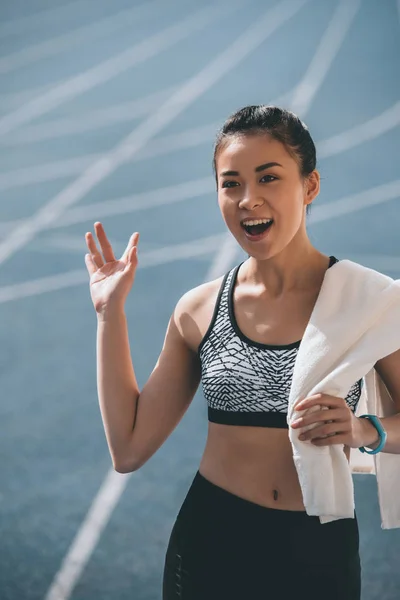 Sportswoman with towel on stadium — Stock Photo