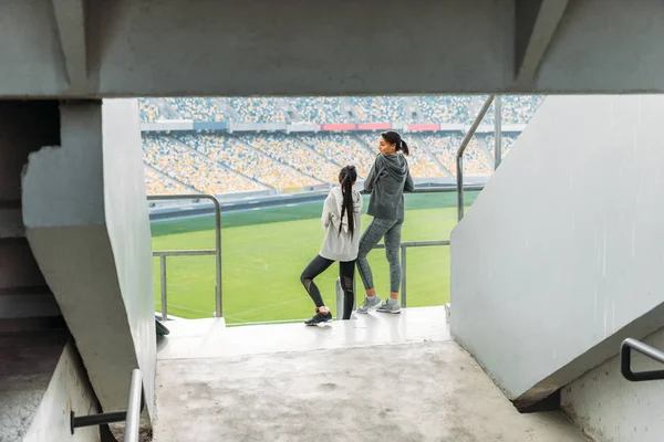 Sportswomen at handrail on stadium — Stock Photo