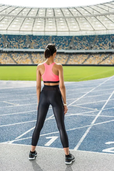 Sportswoman exercising on stadium — Stock Photo