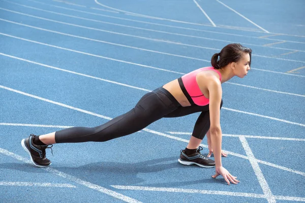 Sportswoman on starting line — Stock Photo