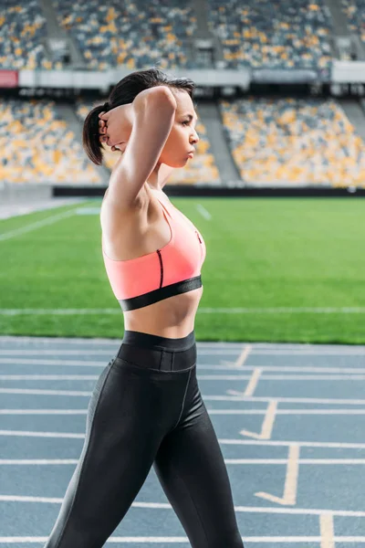 Sportswoman on running tracks — Stock Photo