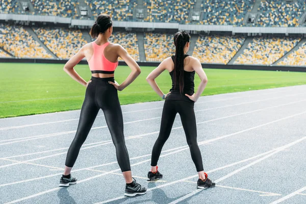 Sportswomen exercising on stadium — Stock Photo