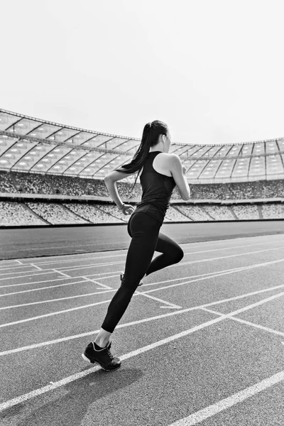 Sportswoman running on stadium — Stock Photo