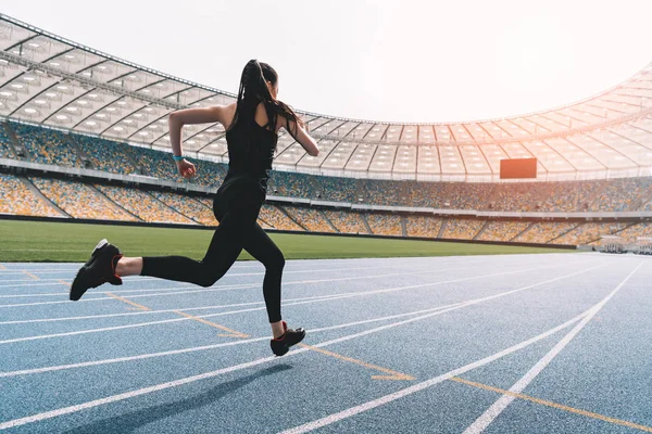 Sportlerin läuft auf Stadion zu — Stockfoto