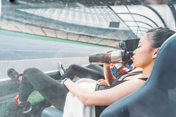 Sportswomen resting on stadium — Stock Photo