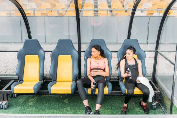 Sportswomen resting on stadium — Stock Photo