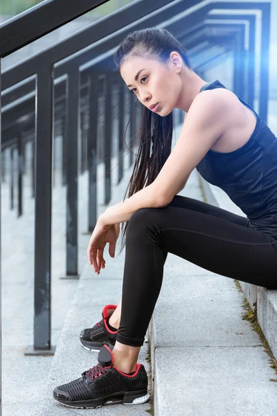 Sportswoman training on stadium stairs — Stock Photo